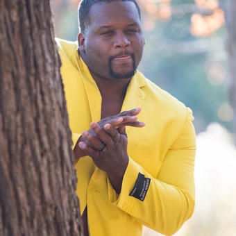 Black guy hiding behind tree
