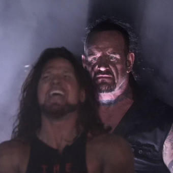 Undertaker Standing Behind AJ Styles